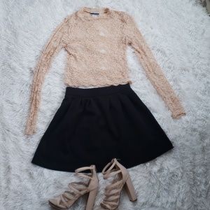 Pink shear crop top and black skirt.